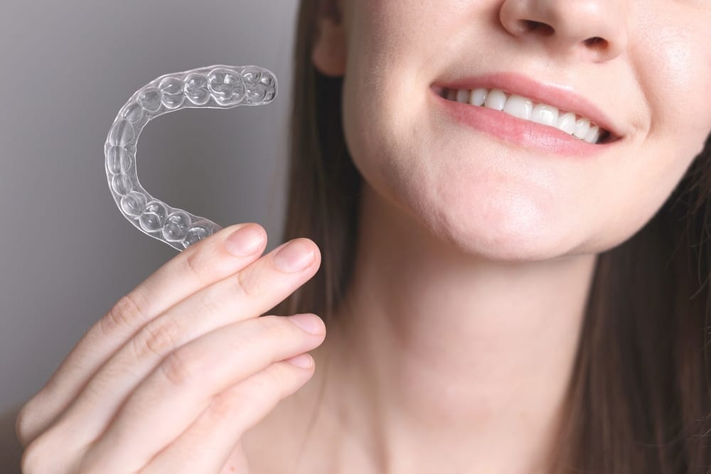 Aligners for straightening teeth in a woman's hand