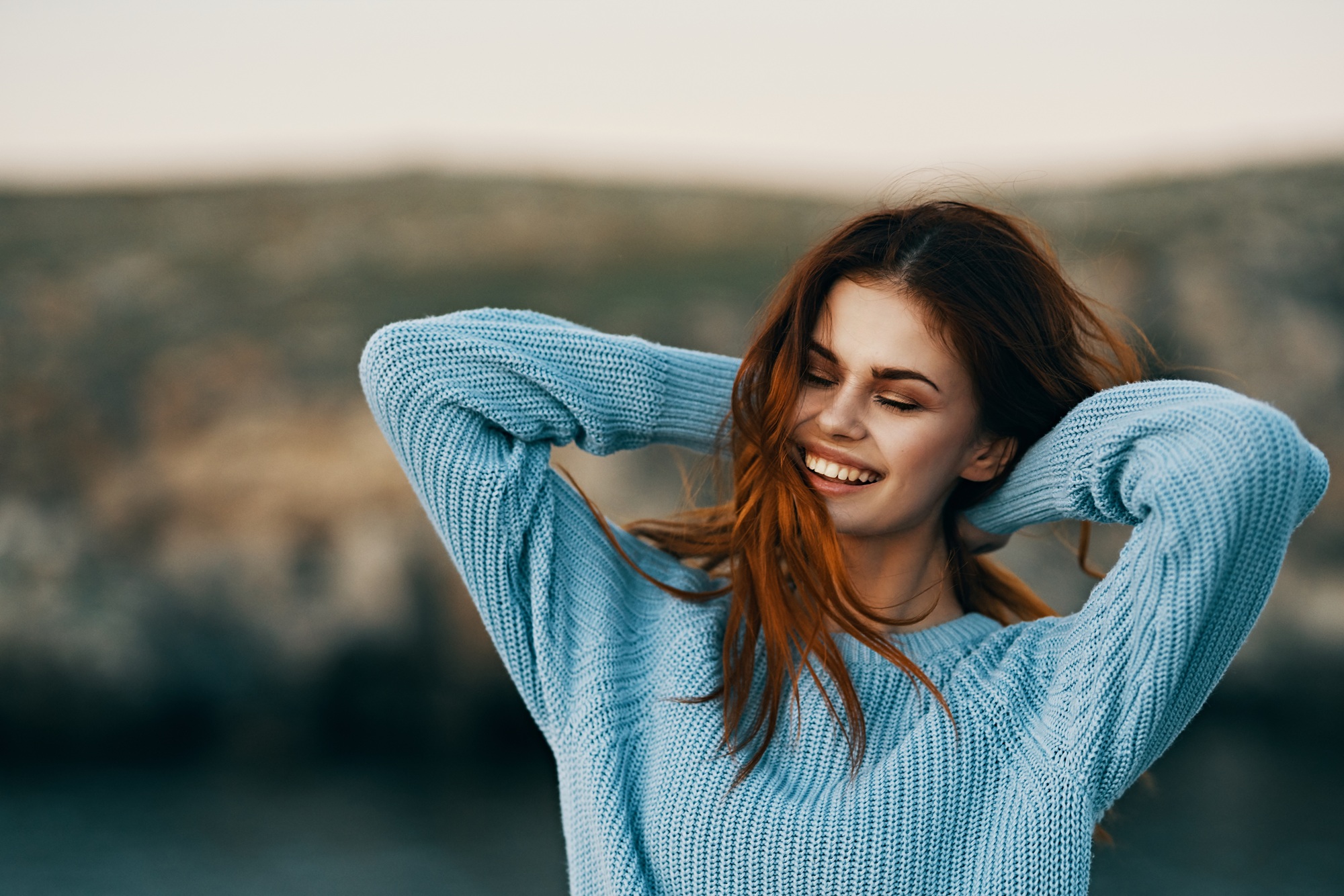 Smiling woman outdoors representing renewed confidence after cosmetic dentistry in the San Marcos and San Diego community