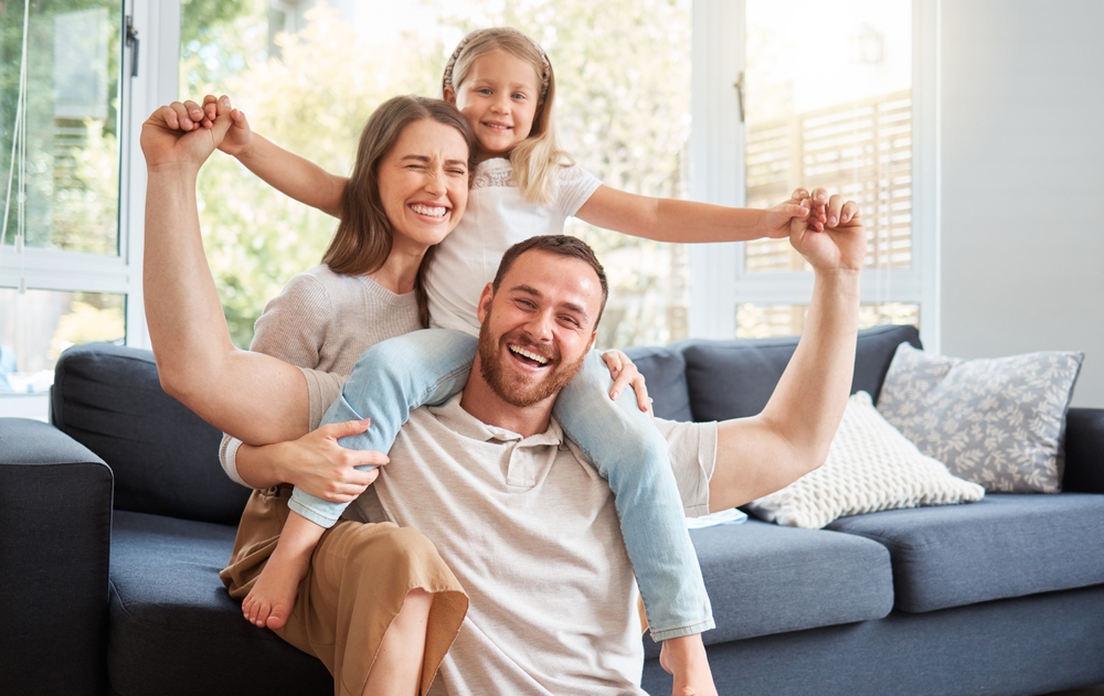 Smiling family at home representing everyday comfort after urgent dental treatment in the San Marcos and San Diego community