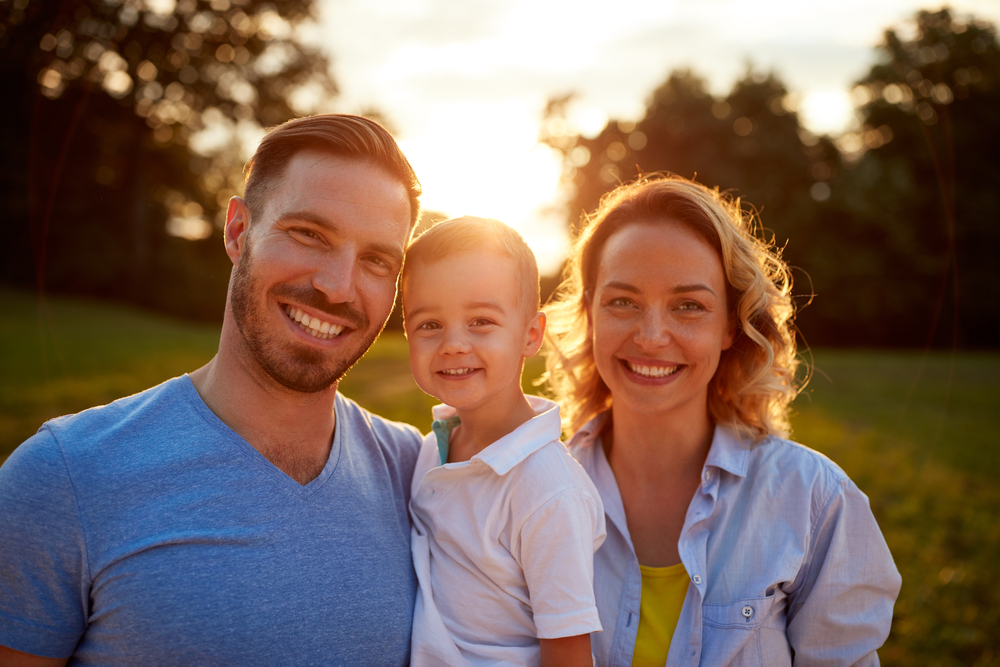 Family-focused dental care in the San Marcos and San Diego community Smiling family outdoors representing welcoming dental care for patients of all ages in the San Marcos and San Diego community
