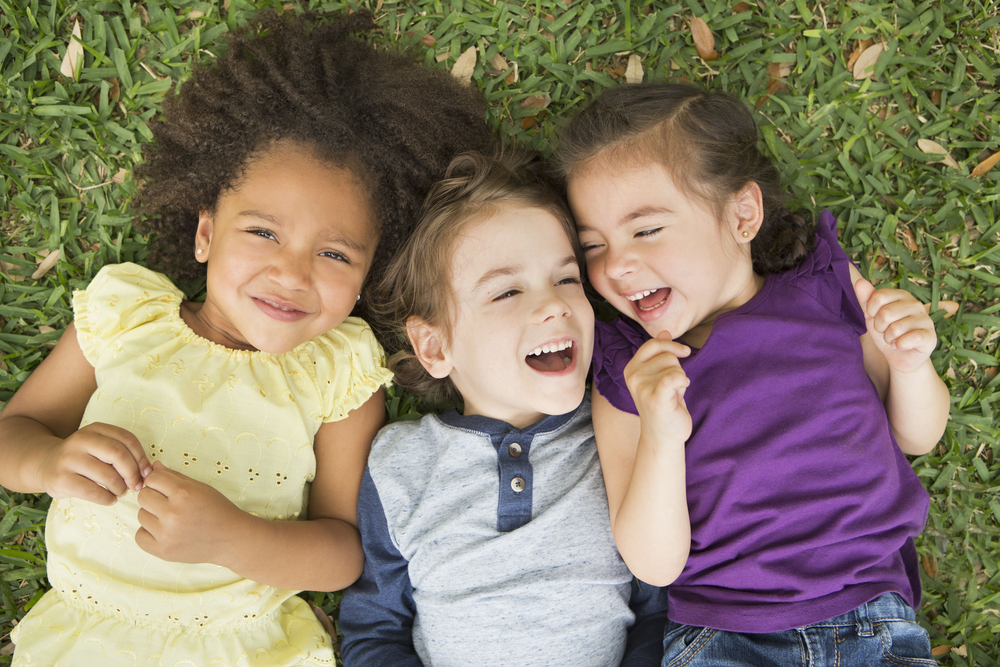 Three smiling children representing positive children’s dental experiences in the San Marcos and San Diego community