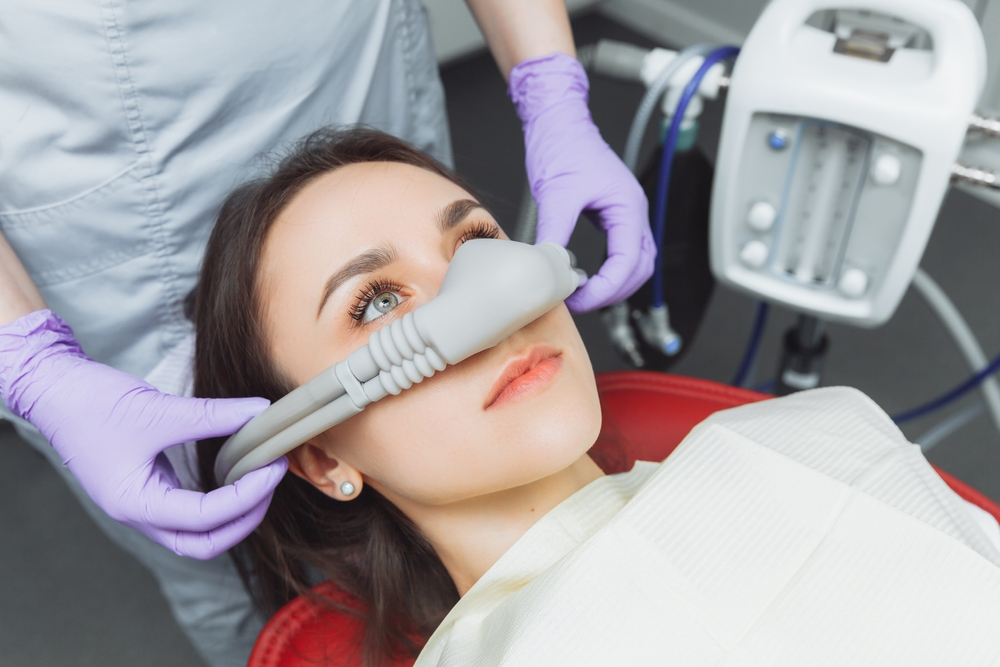 Patient receiving nitrous oxide through a nasal mask during a relaxed dental appointment