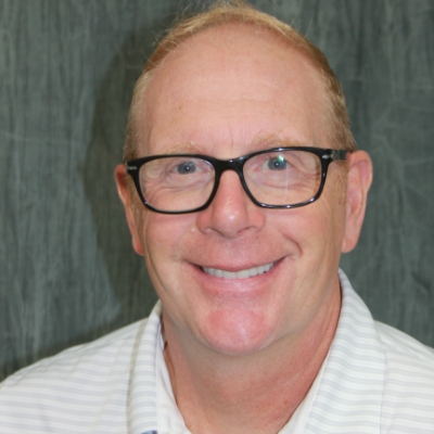 Restorative dental implant care for missing teeth Smiling man with glasses displaying a complete smile after restorative implant care in the San Marcos and San Diego community