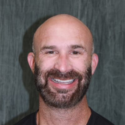 Personalized implant care for a restored smile Smiling man displaying restored teeth after personalized dental implant care in the San Marcos and San Diego community