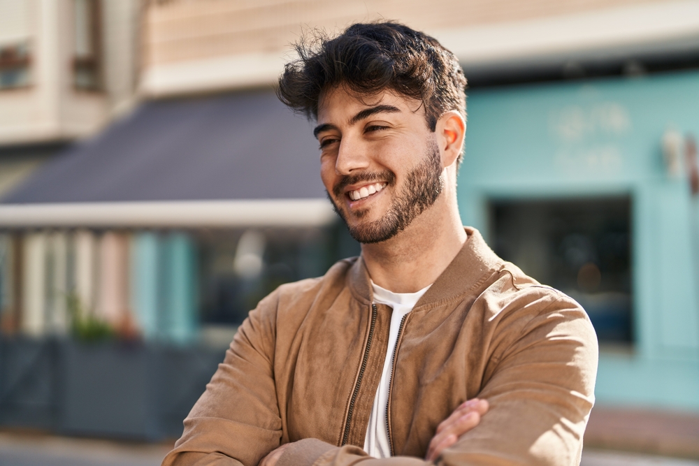 Smiling man outdoors representing relief and confidence after emergency dental care in the San Marcos and San Diego community