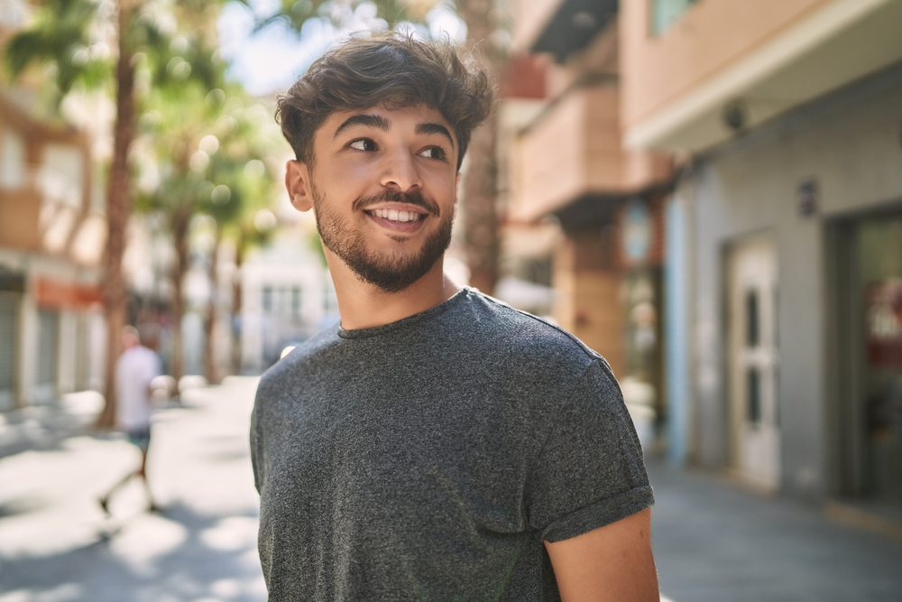 Smiling man outdoors after restoring his confidence with All-on-X dental implants in the San Marcos and San Diego community